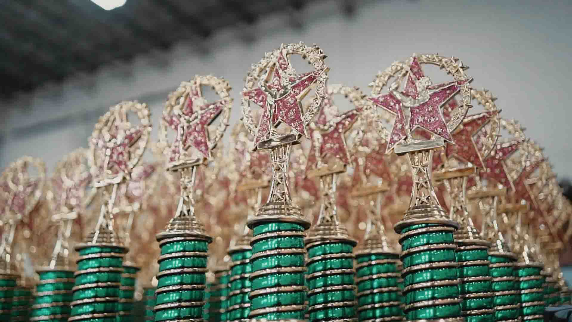 Rows of Rhythmic Art Invitational trophies photographed before competition