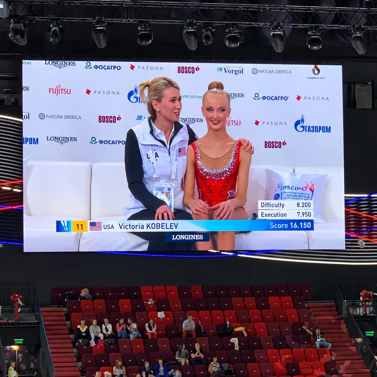 Rhythmic Art head coach Elena Nikolashkina and Victoria Kobelev on the event screen after a rhythmic gymnastics performance