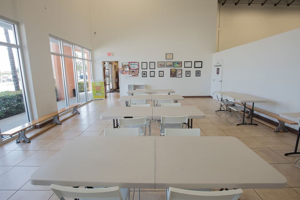 Rhythmic Art parent waiting area with tables and chairs